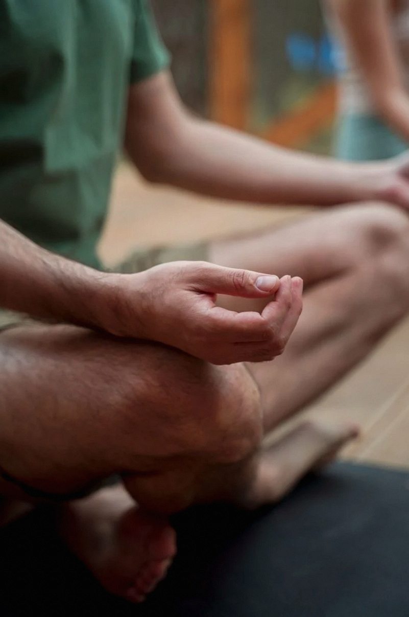 Hands resting in a seated meditation posture
